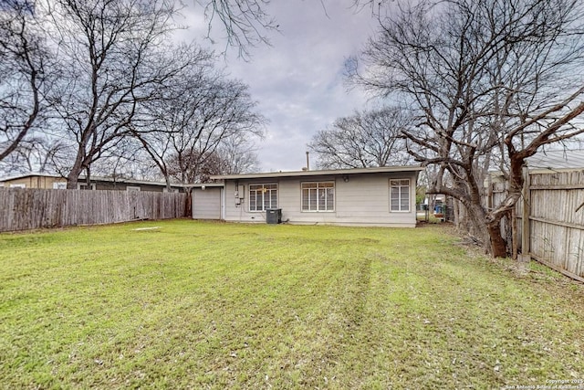 back of property featuring a lawn and a fenced backyard