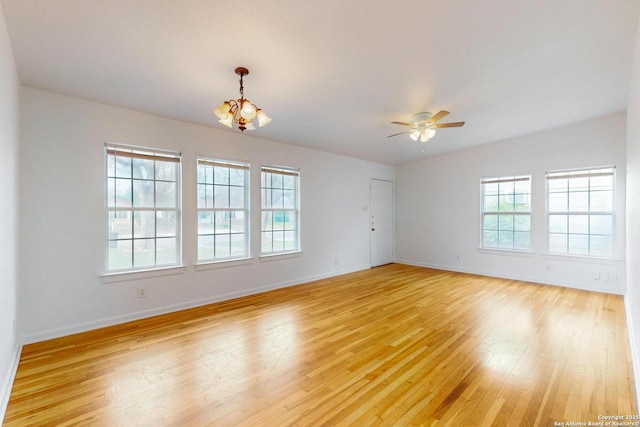 unfurnished room featuring light wood-type flooring, plenty of natural light, baseboards, and ceiling fan