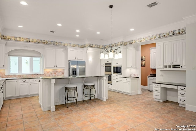 kitchen featuring a center island, a breakfast bar area, stainless steel appliances, visible vents, and white cabinets