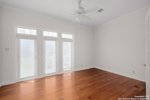 unfurnished room featuring a wealth of natural light and hardwood / wood-style floors