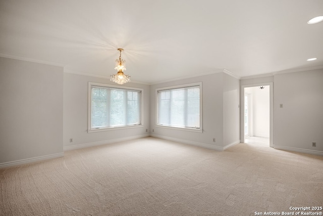 empty room with baseboards, ornamental molding, and light colored carpet