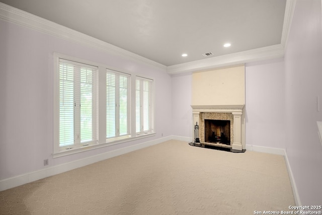 unfurnished living room with baseboards, a fireplace, visible vents, and ornamental molding