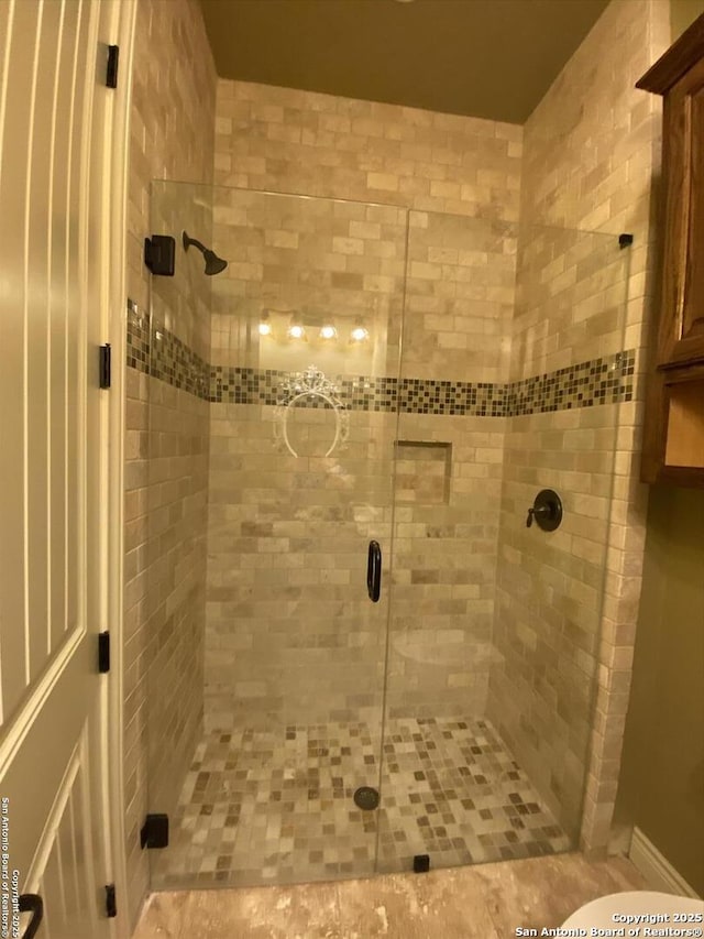 bathroom with a shower stall