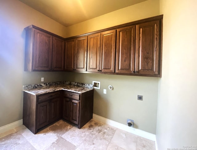 washroom with cabinet space, hookup for a washing machine, baseboards, and hookup for an electric dryer