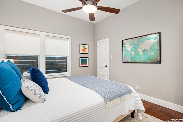 bedroom with baseboards, wood finished floors, and a ceiling fan