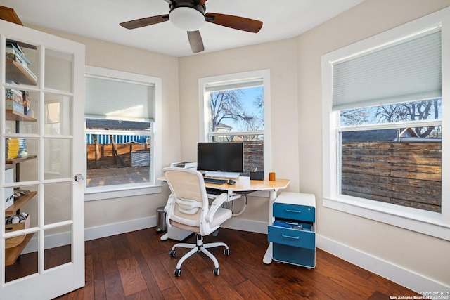 office space with dark wood-type flooring, a ceiling fan, and baseboards