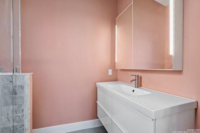 bathroom with baseboards and vanity