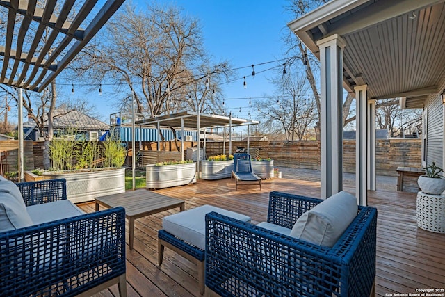 wooden terrace with an outdoor living space, a pergola, and fence