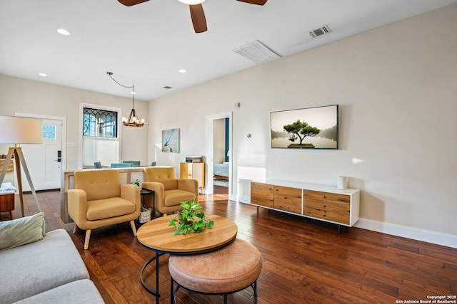 living room featuring hardwood / wood-style flooring, recessed lighting, baseboards, and visible vents