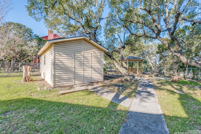 view of shed with fence and a gazebo