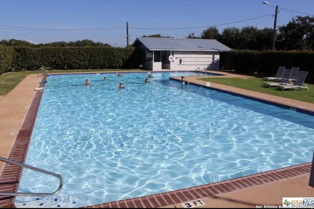 community pool with an outdoor structure