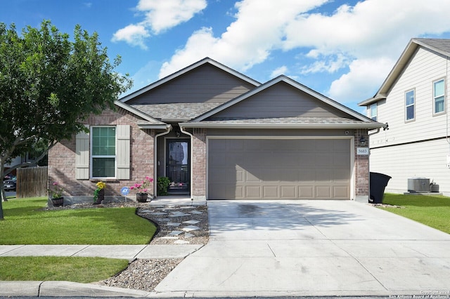 ranch-style home featuring a garage, concrete driveway, a front lawn, central AC, and brick siding