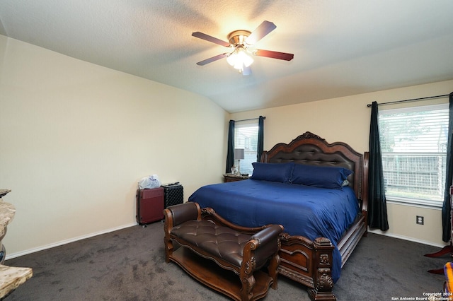 carpeted bedroom with vaulted ceiling, baseboards, and ceiling fan