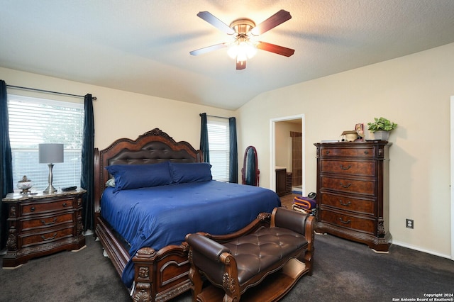 carpeted bedroom featuring multiple windows, vaulted ceiling, baseboards, and ceiling fan