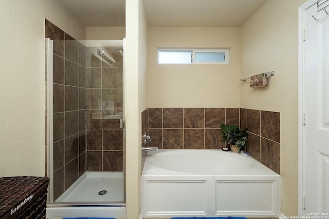 full bathroom featuring a shower stall and a bath