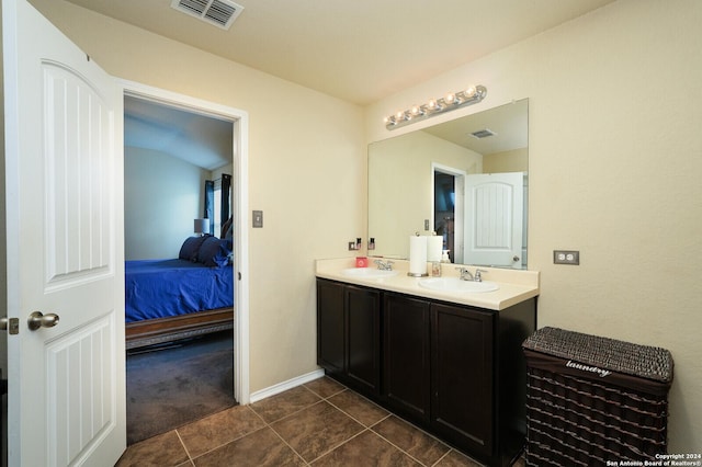 full bath featuring double vanity, visible vents, a sink, and ensuite bathroom