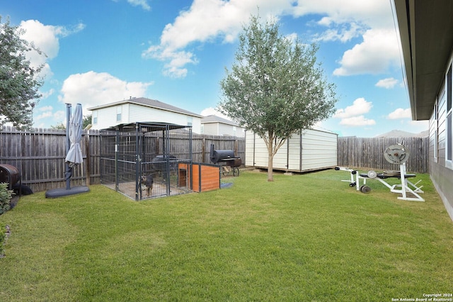 view of yard with a fenced backyard and an outdoor structure