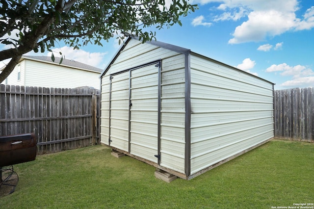 view of shed with a fenced backyard