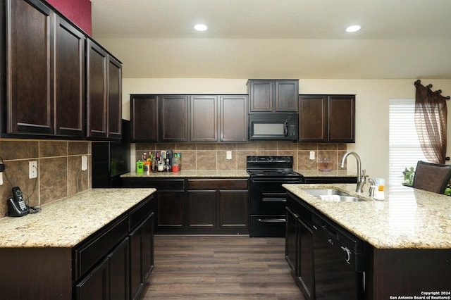 kitchen with decorative backsplash, dark wood-style flooring, dark brown cabinets, black appliances, and a sink