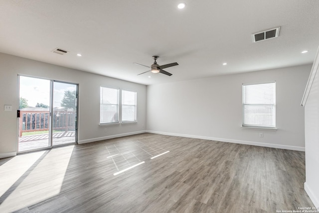 unfurnished room with recessed lighting, visible vents, baseboards, and wood finished floors