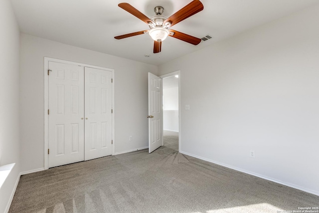 unfurnished bedroom with carpet, a closet, visible vents, and baseboards