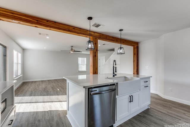 kitchen with a sink, beam ceiling, visible vents, and dishwasher