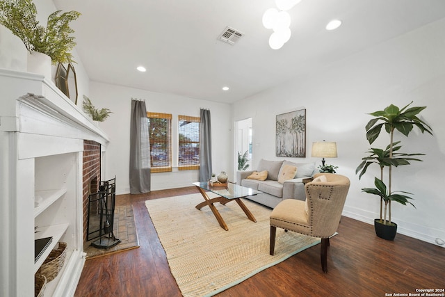 living room featuring a fireplace, wood finished floors, visible vents, and recessed lighting