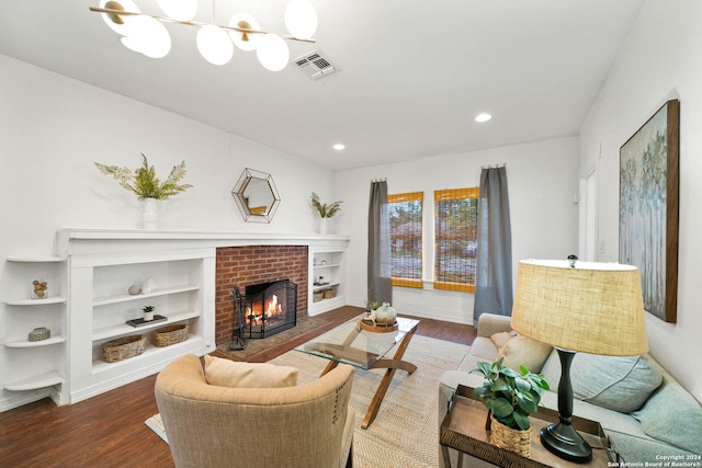 living area with built in shelves, recessed lighting, a fireplace, wood finished floors, and visible vents