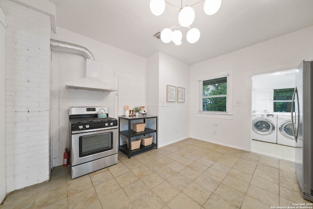 kitchen featuring light tile patterned flooring, a notable chandelier, premium range hood, appliances with stainless steel finishes, and washing machine and clothes dryer