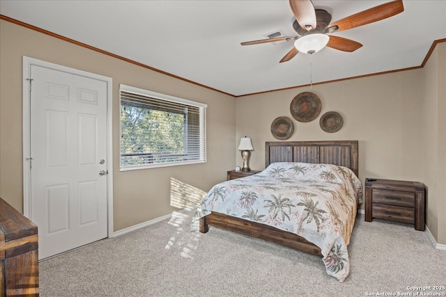 carpeted bedroom featuring baseboards, ornamental molding, and a ceiling fan