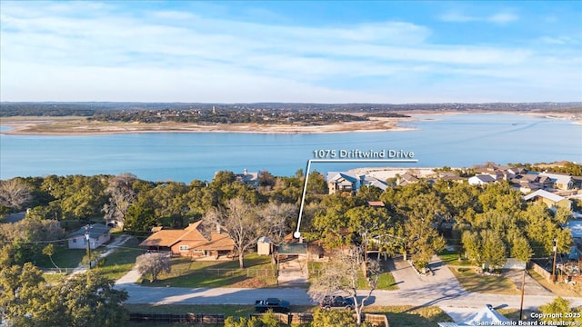 birds eye view of property with a water view