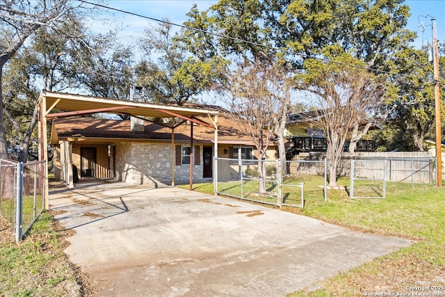 view of front of home with a carport, stone siding, concrete driveway, and a gate