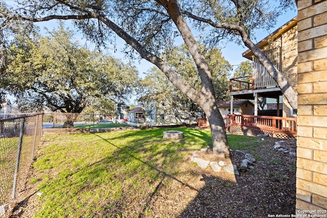 view of yard featuring fence and a deck