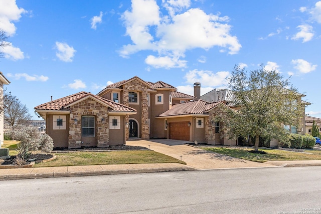 mediterranean / spanish house featuring a garage, a tile roof, concrete driveway, stone siding, and a chimney