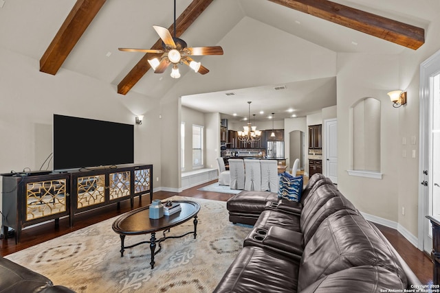 living area with dark wood-type flooring, beam ceiling, and baseboards