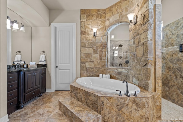 bathroom featuring a walk in shower, vanity, and a bath