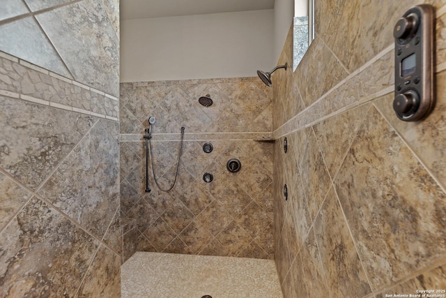 bathroom with tiled shower