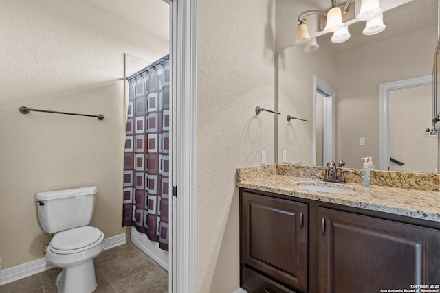 full bathroom with toilet, shower / bath combo with shower curtain, vanity, tile patterned flooring, and baseboards