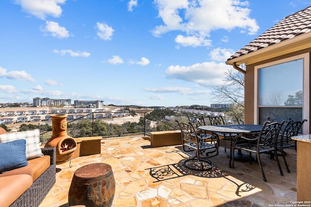 view of patio / terrace with outdoor dining space and a city view