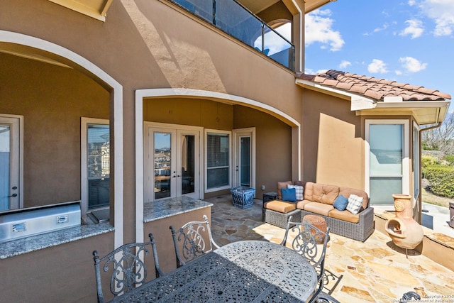 view of patio / terrace with an outdoor hangout area, french doors, outdoor dining area, and an outdoor kitchen