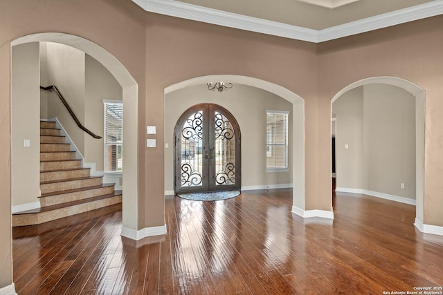 foyer featuring french doors, hardwood / wood-style floors, and baseboards