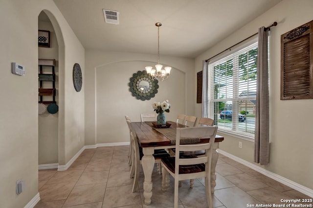 dining space with visible vents, a notable chandelier, baseboards, and light tile patterned floors