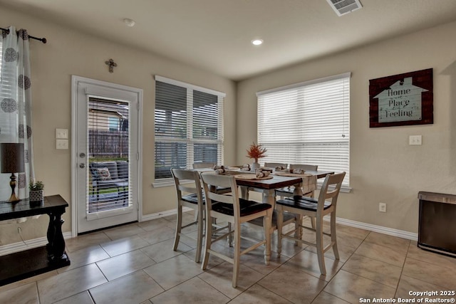 dining space with visible vents, baseboards, and light tile patterned floors