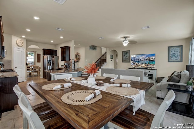 dining room featuring stairs, arched walkways, visible vents, and recessed lighting