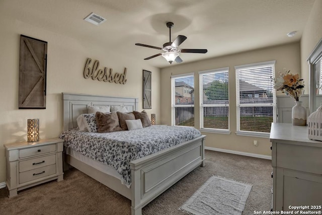 bedroom with a ceiling fan, baseboards, visible vents, and carpet flooring