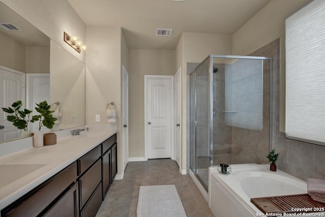 bathroom with a sink, a shower stall, and visible vents