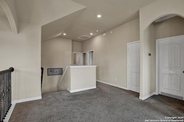 spare room featuring recessed lighting, carpet flooring, visible vents, baseboards, and vaulted ceiling