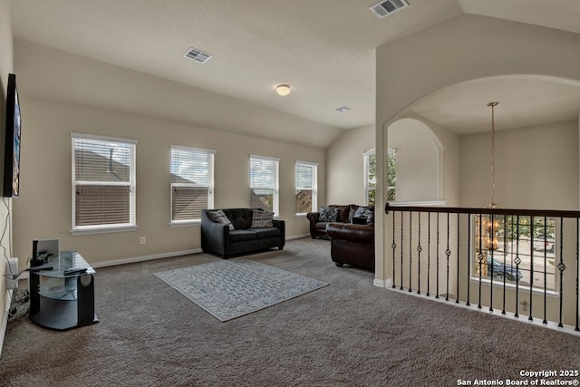 living area featuring lofted ceiling, baseboards, visible vents, and carpet flooring