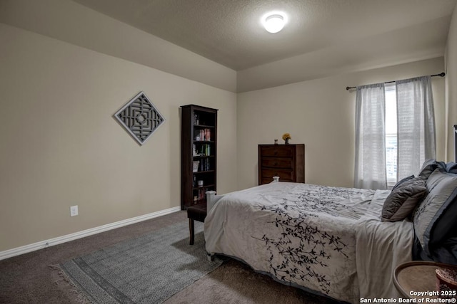 carpeted bedroom featuring baseboards and a textured ceiling