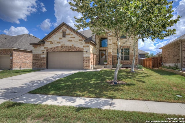 view of front of property featuring an attached garage, brick siding, fence, driveway, and a front lawn